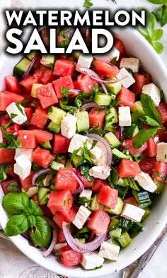 watermelon salad with feta cheese, onions and herbs in a white bowl