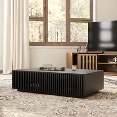 a living room scene with focus on the television and coffee table in front of the window