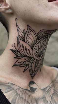 a woman's neck with a tattoo on it