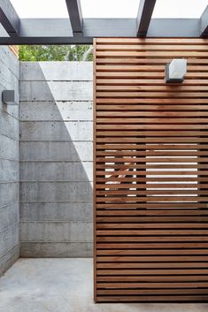 an outdoor shower with wooden slats on the wall