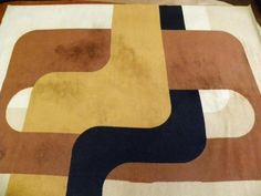 an area rug with various colored shapes on it