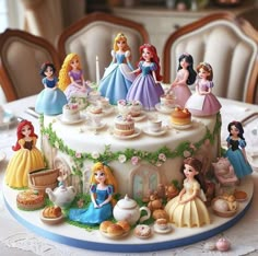 there is a cake decorated with princess figurines on the table