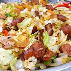 a plate full of sausage and cabbage salad