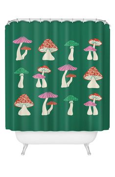 a green shower curtain with mushrooms on it