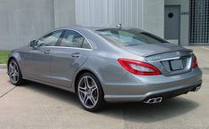 a silver car parked in front of a building