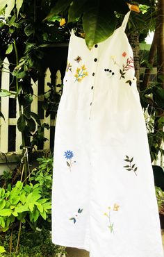 ❤ The white linen hand embroidered dress is very soft, skin friendly, breezy and comfortable. ❤ Item description: - A lovely dress with colourful embroidered wild flowers and bee motifs. - Material: linen, coconut button, embroidery threads. - Environmentally friendly. - This dress is very useful, go with any outfit, that can be used to go to school, go out, go shopping. It is a perfect gift for yourself or your beloved. ❤ Care instructions: Hand washing / delicate washing at 86 ºF/30oС. ❤ Note: White Dresses With Embroidery, White Cotton Embroidered Dress For Vacation, White Embroidered Cotton Dress For Vacation, White Linen Dress For Summer Garden Party, White Embroidered Dress For Garden Party, White Linen Button Dress For The Beach, White Linen Dress With Buttons For The Beach, White Cotton Embroidered Dress For Garden Party, Summer Linen Dress With Floral Embroidery For Garden Party