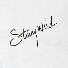 someone has written the word stay wild on a piece of paper with a pen in it