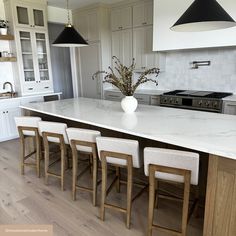 a large kitchen island with six chairs around it