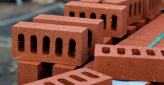 bricks are stacked on top of each other in order to be used for construction purposes