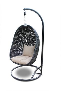 a black swing chair with a white pillow on it