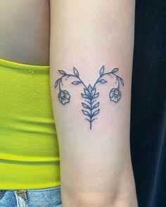 a woman's arm with a flower tattoo on the left side of her arm