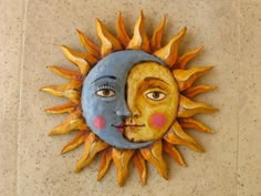 a sun and moon face on the wall