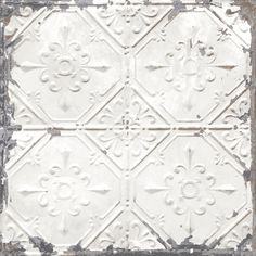 an old white tin ceiling tile with fleur de lis