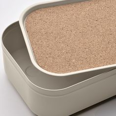 an empty white container with some sand in it