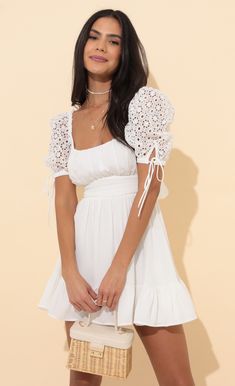 Strut your stuff in this oh so adorable princess dress. The Shay will have all eyes on you due to the lace puff sleeves, square neckline and flared skirt. Made in our white chiffon fabric. Pair with white sneakers or nude heels for a day to night look we are loving. 
	 
	Made in Los Angeles
	 
	- 100% Polyester 
	- Fully Lined 
	- Hand Wash Cold 
	 
	Length of Dress 31in/78.7cm 
	All Measurements Are For A Size Small White Lace Puff Sleeve Dress For Spring, White Lace Puff Sleeve Dress With Lace Trim, Chic Lace Puff Sleeve Dress For Summer, Feminine Lace Puff Sleeve Dress For Summer, Summer Lace Puff Sleeve Dress, White Lace Puff Sleeve Elegant Dress, Feminine White Mini Dress With Lace-up Back, Elegant White Lace Puff Sleeve Dress, Elegant White Puff Sleeve Dress With Lace Trim