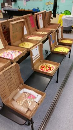 several pizza boxes sitting on top of a table