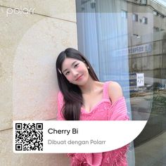 a woman leaning against a wall wearing a pink top