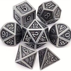 six metal dice with numbers on them