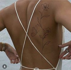 the back of a woman's body with flowers on it