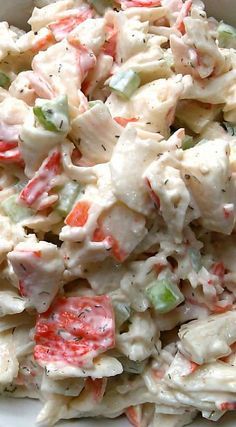 a white bowl filled with chicken salad on top of a table