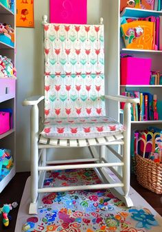 a child's rocking chair in the corner of a playroom