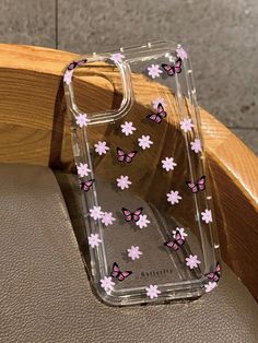 a clear case with pink flowers and butterflies on it