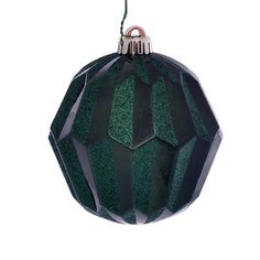 a green and black ornament hanging from a string