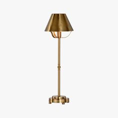 a brass colored floor lamp on a white background