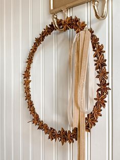 a wreath hanging on the wall with ribbon