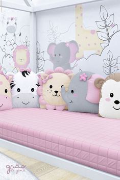 there are many stuffed animals sitting on the pink bedding in this children's room