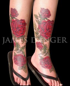 a woman's legs with roses tattooed on them