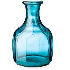 a blue glass vase sitting on top of a white table