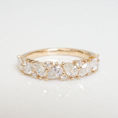 a yellow gold ring with five pear shaped diamonds