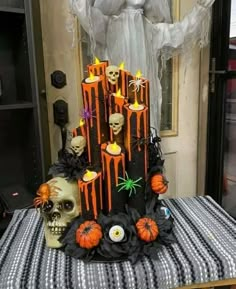 a table topped with halloween decorations and candles