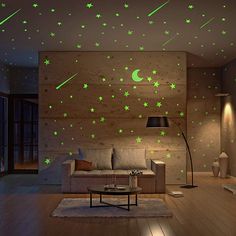 a living room filled with furniture and green stars on the wall above it is a couch