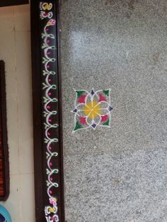 a mirror sitting on the side of a wall next to a vase and other items