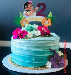 a birthday cake decorated with flowers and the number two on it's tiers