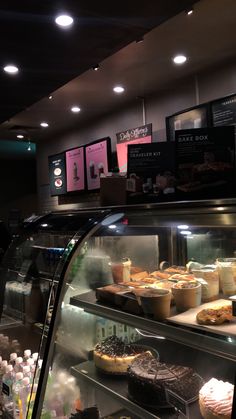 a display case in a bakery filled with lots of cakes and pies on top of it