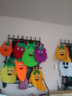 there are many different fruits and vegetables hanging on the wall in front of each other