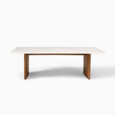 a white marble table with wooden legs