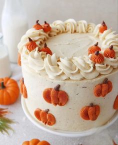 a cake with frosting and pumpkins on it