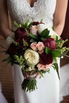 a bride holding a bouquet of flowers in her hands