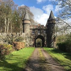 an old stone castle with a gate leading to it