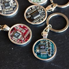 six different types of electronic components on a black surface with one keychain in the middle