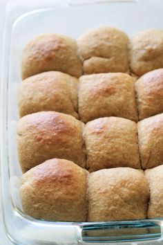 a glass baking dish filled with bread rolls