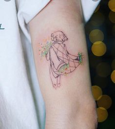 a woman's arm with a small tattoo of a girl holding flowers on it