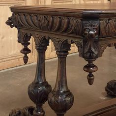 an ornately carved wooden table in a room