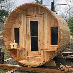 a large wooden barrel sitting in the middle of a yard