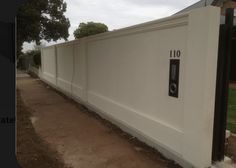 a large white fence with numbers on it