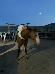 a man riding on the back of a brown horse